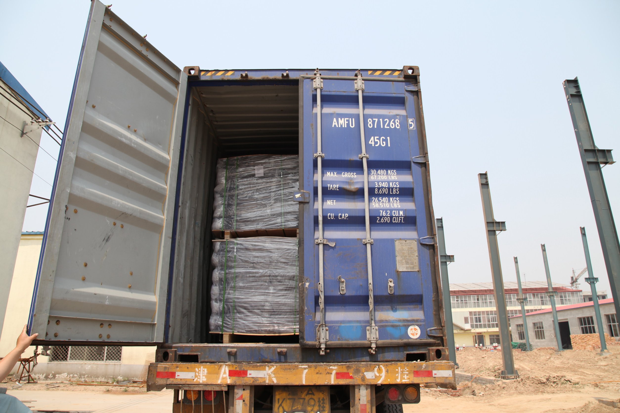 Packed metal mesh being loaded into an export shipping container